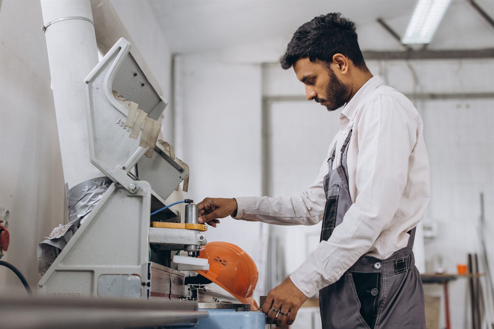 An operator running a CNC machine at an Indian manufacturing unit