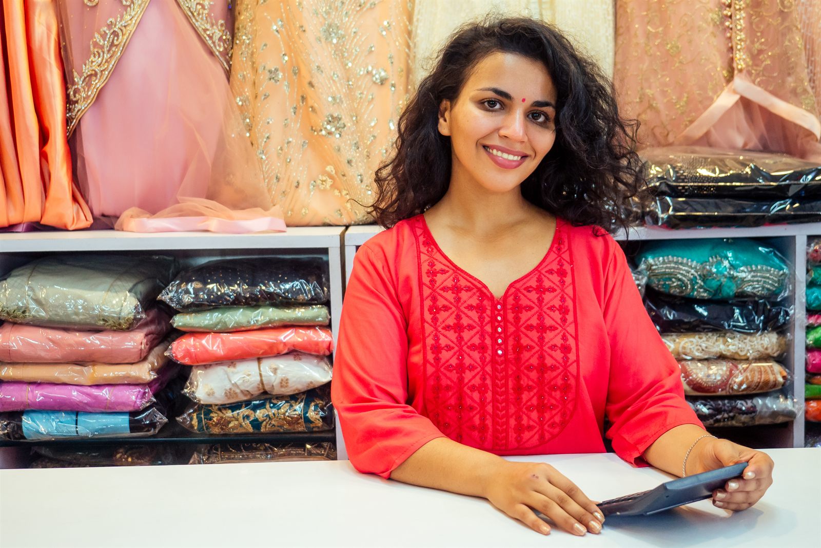 A business owner checking stock in her showroom in India