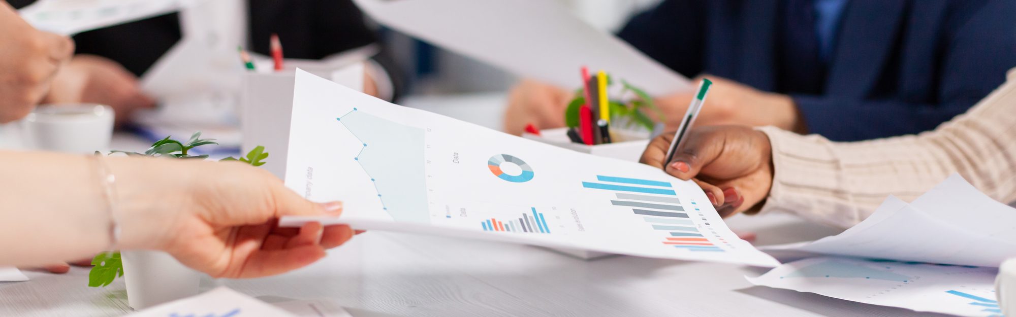A business team reviewing financial reports together at a meeting