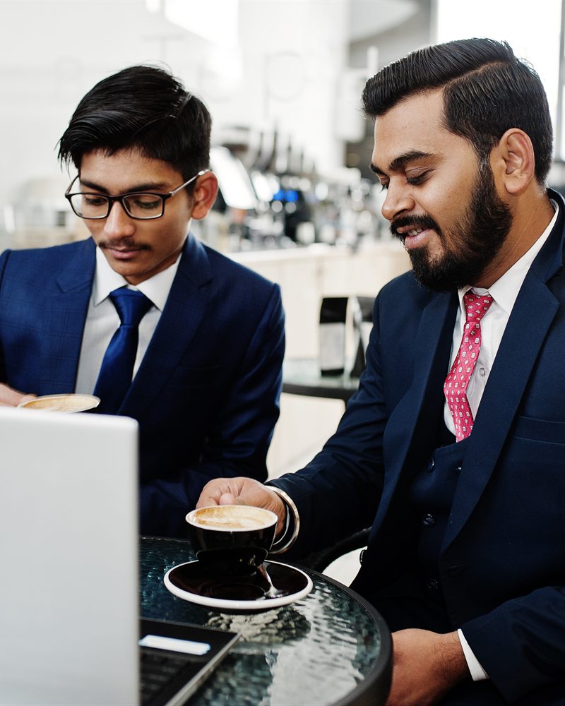 A manager and professional discussing over a laptop