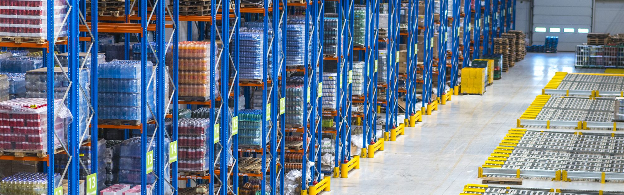 Goods stacked on tall racks inside a distribution warehouse